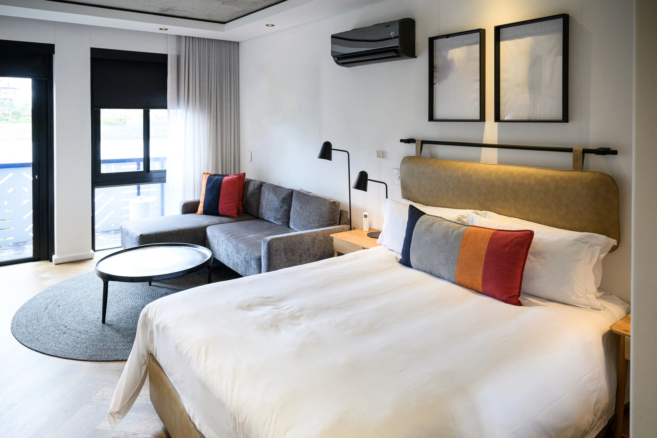 Contemporary hotel suite with king bed and minimalist interior