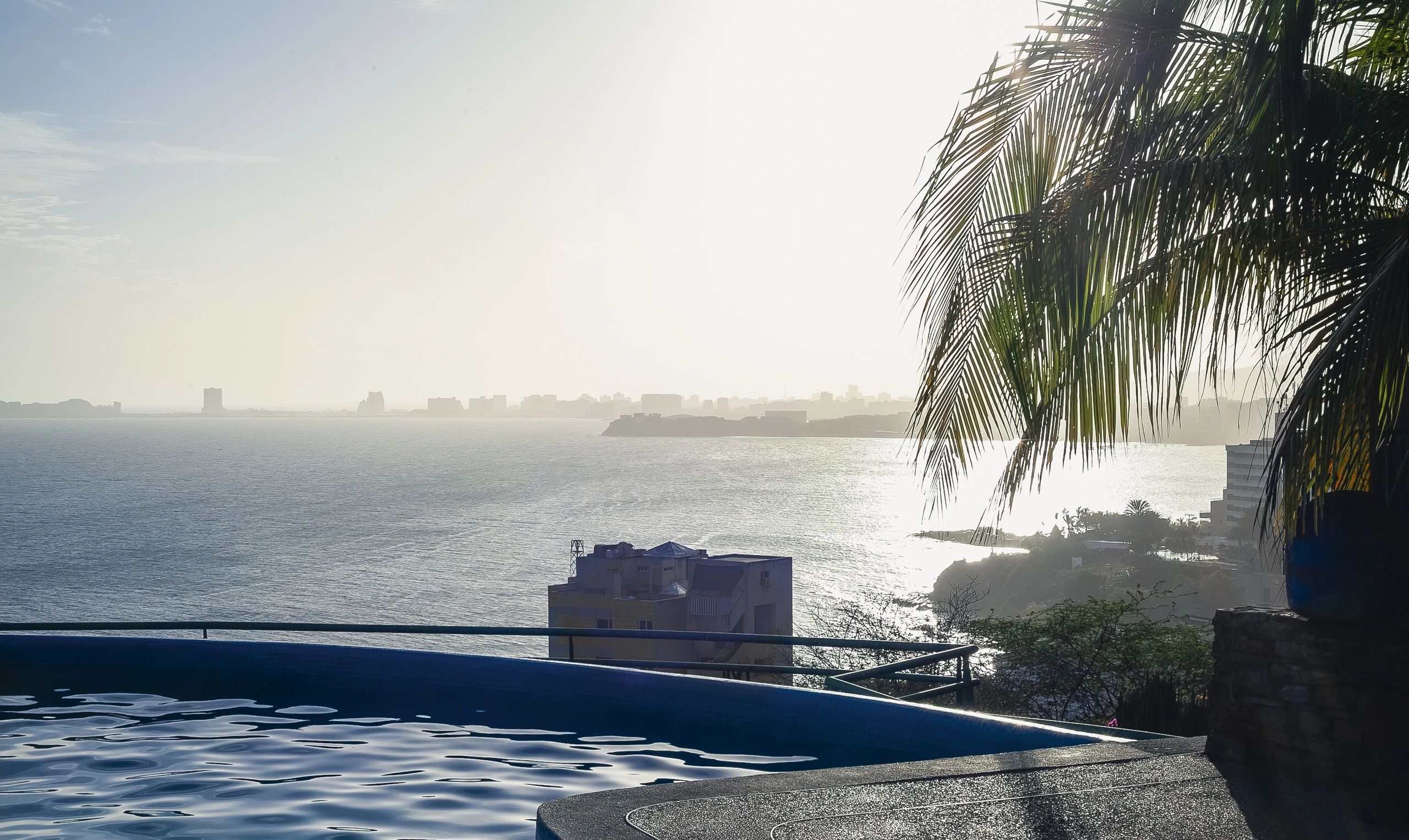 Infinity pool at a resort overlooking the ocean at sunset